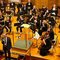 President Walter Saul addressing audience at orchestra concert, 2023