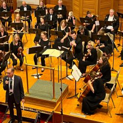 President Walter Saul addressing audience at orchestra concert, 2023